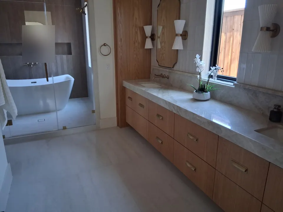 Sparkling spa bathroom with freestanding tub and wood vanity after cleaning